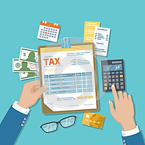 Man calculates tax. Payment of tax, accounts, bills concept. Calculator, calendar, tax form for the clipboard, checks, money