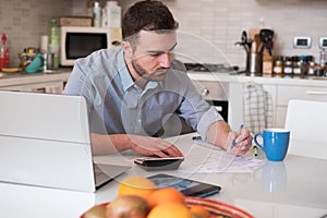 Man calculating bills and tax expense