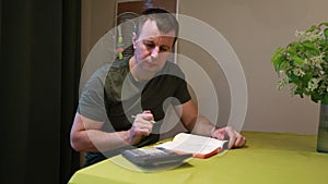 Man Calculating Budget With Calculator and Notebook at Home During Evening