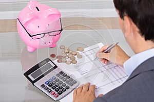 Man calculating savings and costs photo