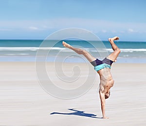 Man, calisthenics and body at sea for exercise with summer, health and wellness. Male athlete, ocean water and activity