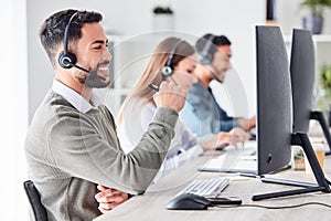 Man, call center and working in team office with headset, computer for online customer support, service or help
