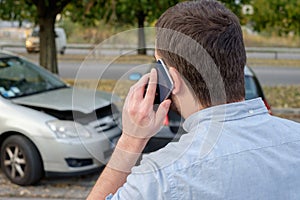 Man calling car mechanic insurance assistance after car accident