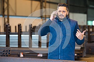 man calling with cell phone in factory