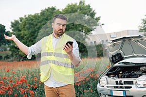 Man calling for help after car breakdown. Car service. Tow service