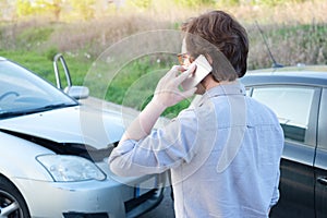 Man calling help after car crash accident on the road