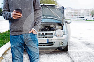 Man calling mechanic after car breakdown