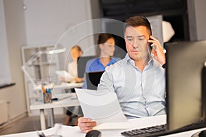 Man calling on smartphone at night office