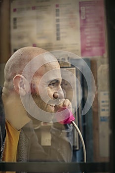 Man calling from a telephone booth