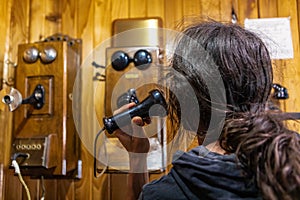 Man calling via wood wall telephone