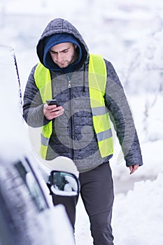 Man calling winter car services to help.