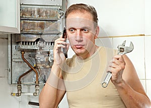The man calls by phone to cause the repairman