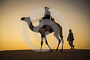 Man with a camel in a desert in Sudan
