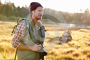 Man with camera in countryside, Big Bear, California, USA