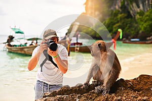 Man, camera and monkey with vacation, beach and tropical island with getaway trip, Bali and travel. Person, photographer