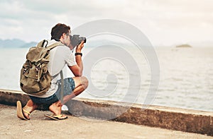 Man, camera and photography at ocean as travel blogger for picture memory for creative, digital or lens. Male person