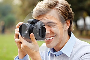 Man, camera and photography for picture in park with digital technology for travel as creative photographer. Happy, male