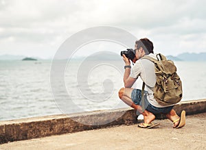 Man, camera and photography by sea as travel journalist for picture memory for creative, digital or lens. Male person