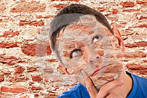 Man camouflaged in front of a wall photo