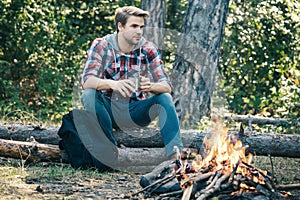 Man camping in forest. Tourists relaxing. Tourism concept. Picnic time.