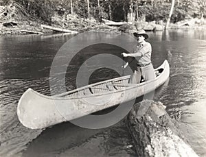 Man canoeing down river