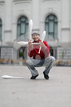 A man in a cap demonstrates maces