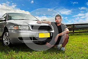 Man beside car in afternoon sun