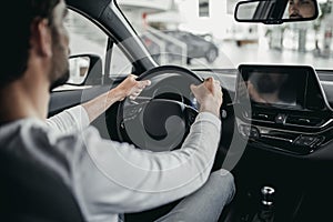 Man in car dealership