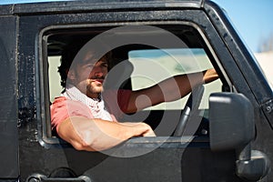 Man, car and driving for road trip, travel or holiday in outdoor journey or adventure in nature. Handsome or attractive