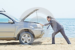 Man with car on seaside