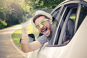 Man in car showing thumbs up