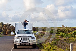 Man On Caravan Trip Taking Photos From Car Sunroof