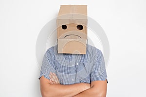 a man with a cardboard box on his head, a sad smiley