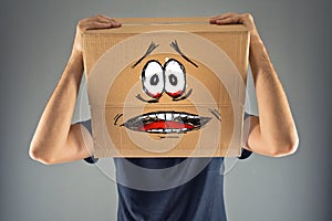 Man with cardboard box on his head and terrified look skethed