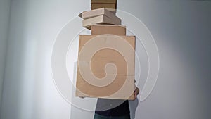 Man with cardboard boxes, delivery male holds and drops things. Falling storage