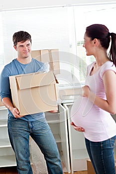 Man with cardboard looking at his pregnant wife