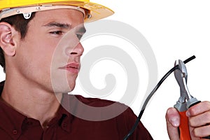 Man carefully cutting wire