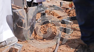 A Man Carefully Planting a plant in the Ground