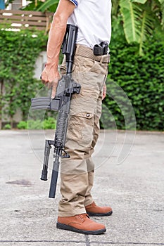 Man in cargo pants with gun