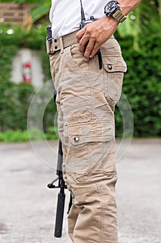 Man in cargo pants with gun