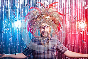 Fun, holiday and april fools day people concept - Strange man with carnival mask and hat