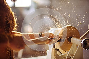 Wood lathe. Carpenter lathing wood photo