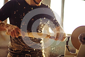 Wood lathe. Carpenter lathing wood photo