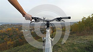 Man carries a bicycle on the mountain