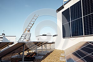 Man carries ladder during solar panels installation