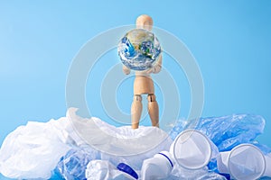 Man carry the planet to save the earth from garbage and plastic. Ecology and waste recycling. Elements furnished by NASA