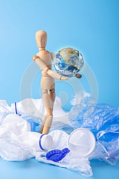 Man carry the planet to save the earth from garbage and plastic. Ecology and waste recycling. Elements furnished by NASA