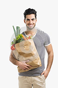 Man carrying a bag full of vegetables