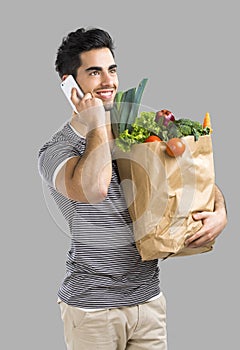 Man carrying a bag full of vegetables