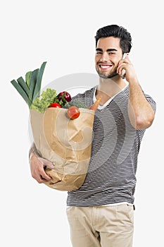 Man carrying a bag full of vegetables